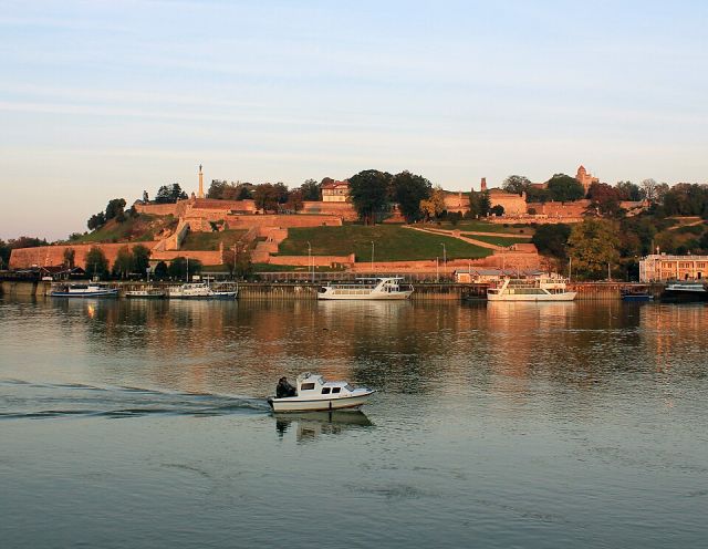 Belgrade Fortress above the river with boats on the waterfront in Serbia
